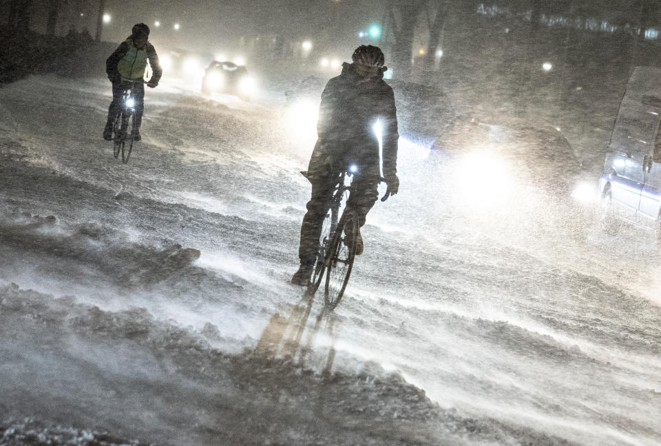 A person on a bicycle drives on a street during heavy snowfall in Aalborg, northern Jutland, Denmark, Wednesday, Jan. 3, 2024. Temperatures have fallen below minus 40 degrees Celsius in the Nordic region for a second day in a row, with the coldest January temperature recorded in Sweden in 25 years as a cold spell grips the area. (Henning Bagger/Ritzau Scanpix via AP)
