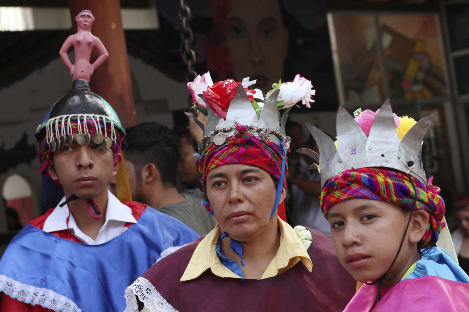 Young Salvadorans wearing traditional costumes listen to California Governor's statements during his visit in Panchimalco, El Salvador, Monday, April 8, 2019. (AP Photo/Salvador Melendez)