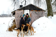Tamara and Yuri Baikov, both 69, stand outside their hut at a small farm situated in a forest near the village of Yukhovichi, Belarus, February 8, 2018. REUTERS/Vasily Fedosenko