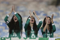 Fans of Mexico's Leon cheer as their team warms up for a Copa Libertadores soccer match against Brazil's Flamengo in Rio de Janeiro, Brazil, Wednesday, April 9, 2014. (AP Photo/Felipe Dana)