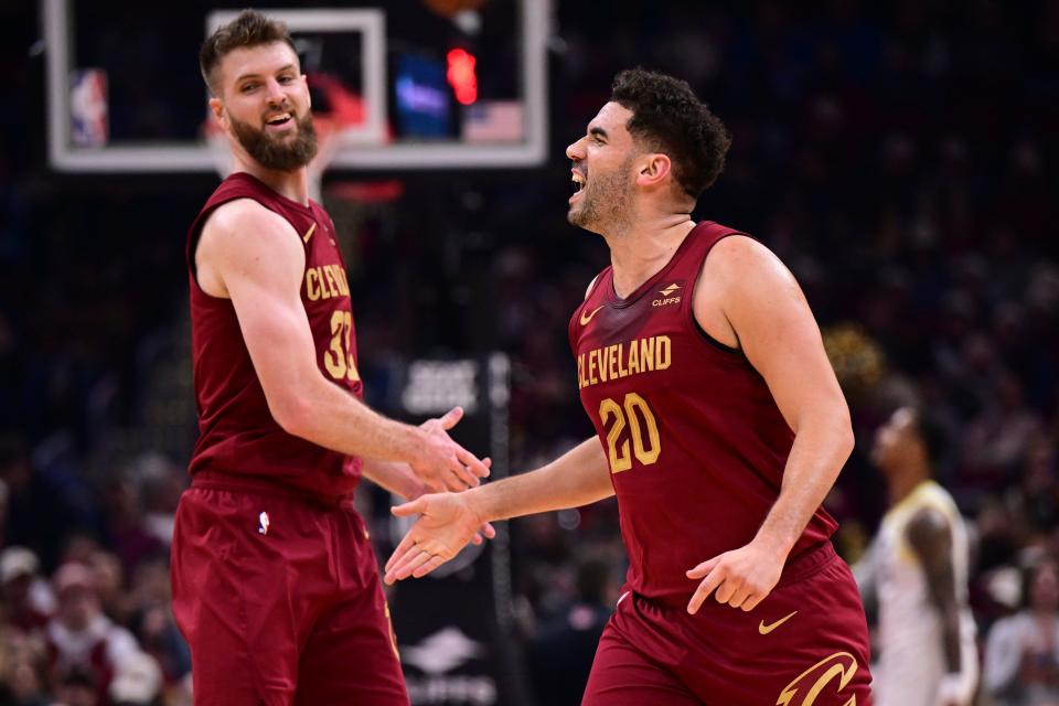 Cleveland Cavaliers forward Georges Niang, front, is congratulated by forward Dean Wade after a 3-pointer against the Utah Jazz on Dec. 20, 2023, in Cleveland.