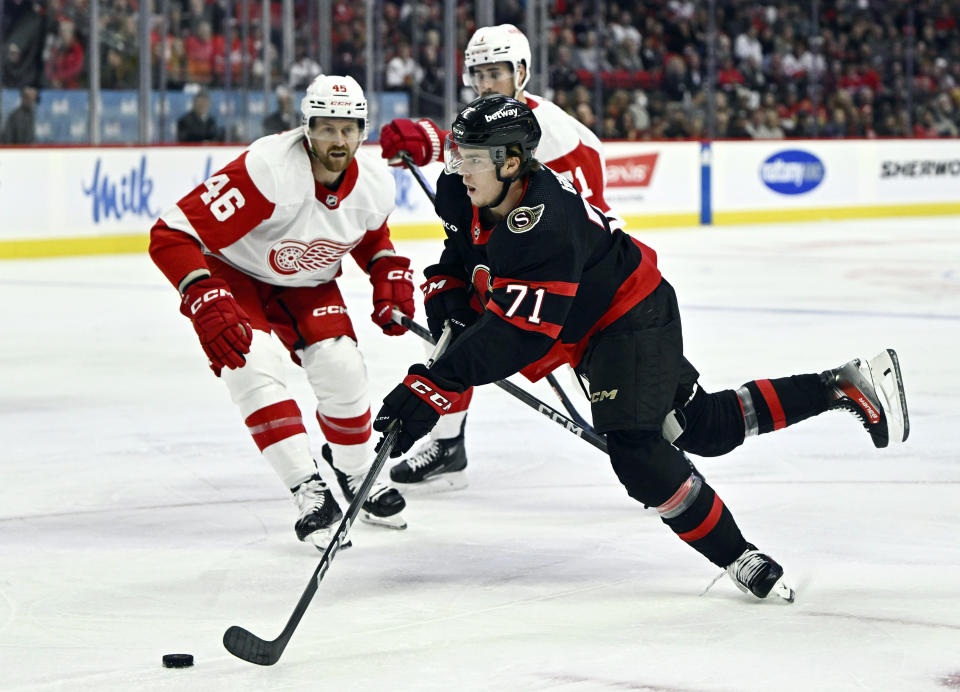 Ottawa Senators centre Ridly Greig (71) turns with the puck past Detroit Red Wings defenceman Jeff Petry (46) during the first period of an NHL hockey action in Ottawa, Ontario, Saturday, Oct. 21, 2023. (Justin Tang/The Canadian Press via AP)