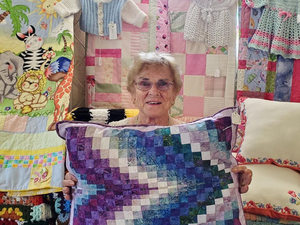 Knitter/quilter Helen Gaughan from Tiverton displays some of the items available at the Tiverton Senior Center Craft Fair.