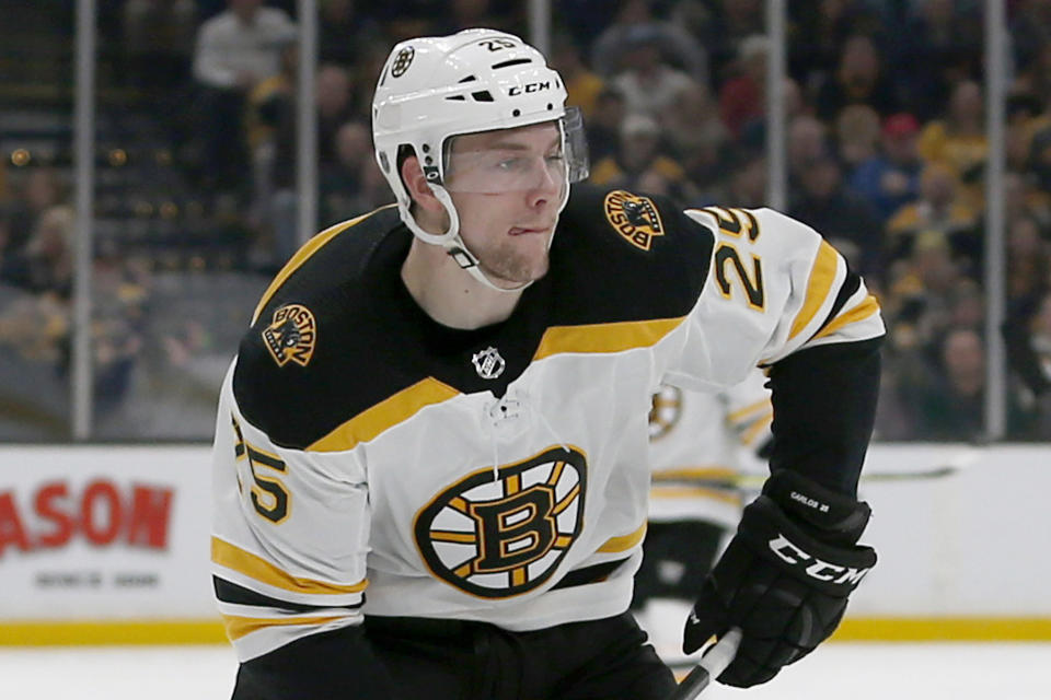 FILE - In this March 5, 2019, file photo, Boston Bruins defenseman Brandon Carlo (25) looks to pass during the second period of an NHL hockey game against the Carolina Hurricanes, in Boston. With NHL training camps set to open this week, roughly a dozen prominent restricted free agents still don’t have contracts, including Tampa Bay’s Brayden Point, Toronto’s Mitch Marner, Boston’s Charlie McAvoy and Brandon Carlo and Colorado’s Mikko Rantanen. Those absences could hang over their teams for days, weeks or even months and have raised questions about why it’s taken so long to get them signed. (AP Photo/Mary Schwalm, File)