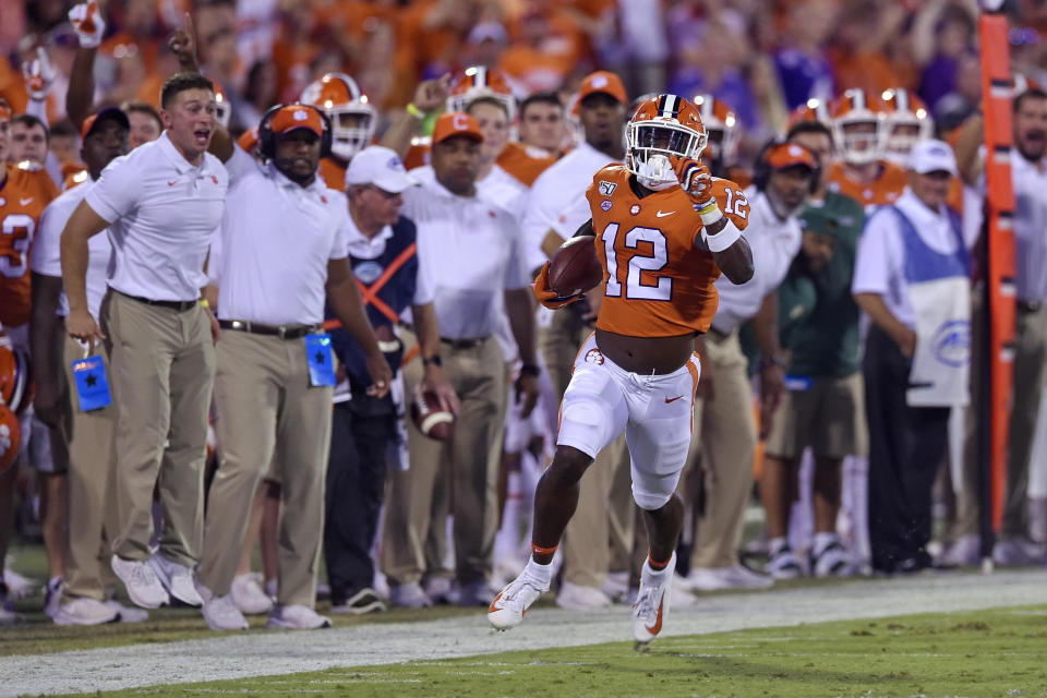 Clemson's K'Von Wallace races down the sideline for a touchdown with an interception during the first half of the team's NCAA college football game against Charlotte on Saturday, Sept. 21, 2019, in Clemson, S.C. (AP Photo/Richard Shiro)