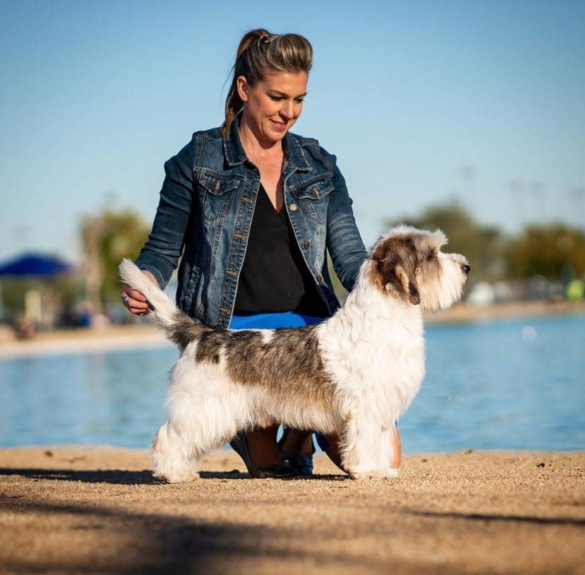 Janice Hayes stands with her dog, Buddy Holly. Holly won Best in Show at the 2023 Westminster Kennel Club Dog Show.