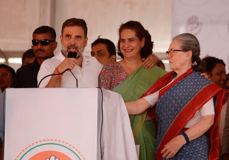 Rahul addresses his supporters as his sister Priyanka, and their mother Sonia Gandhi look on during an election campaign rally in Raebareli