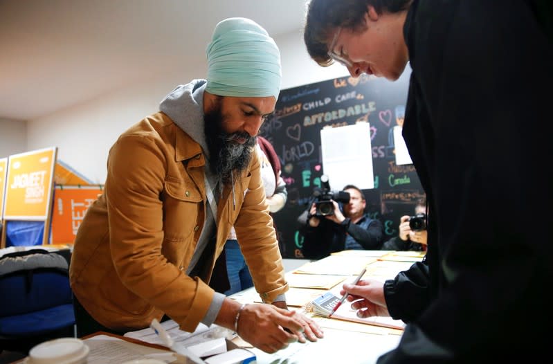 NDP leader Jagmeet Singh helps volunteer Keane at the NDP election office on Election Day in Burnaby
