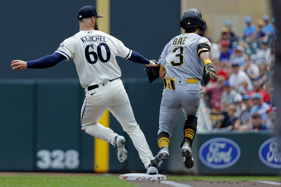 Minnesota Twins starting pitcher Dallas Keuchel beats out Pittsburgh Pirates' Ji-Hwan Bae in a foot race for the putout on a ground ball hit to first base in the first inning of a baseball game Sunday, Aug. 20, 2023, in Minneapolis. (AP Photo/Bruce Kluckhohn)