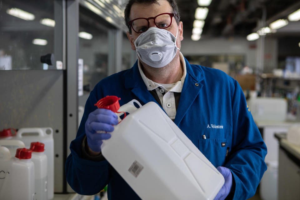 MILAN, ITALY - MARCH 19: Professor Alessandro Volonterio, wearing gloves and a protective face mask, shakes a jerrycan as he works inside the laboratory of Chemistry, Materials and Chemical Engineering 'Giulio Natta' at Politecnico di Milano on March 19, 2020 in Milan, Italy. Following the national shortage of hand sanitiser products due to the novel Coronavirus outbreak, Italy's largest technical university the Politecnico di Milano has started producing hand sanitiser to be delivered to the Protezione Civile, the Italian body dealing with the management of emergency events. The Italian government continues to enforce the nationwide lockdown measures to control the spread of COVID-19. (Photo by Emanuele Cremaschi/Getty Images)