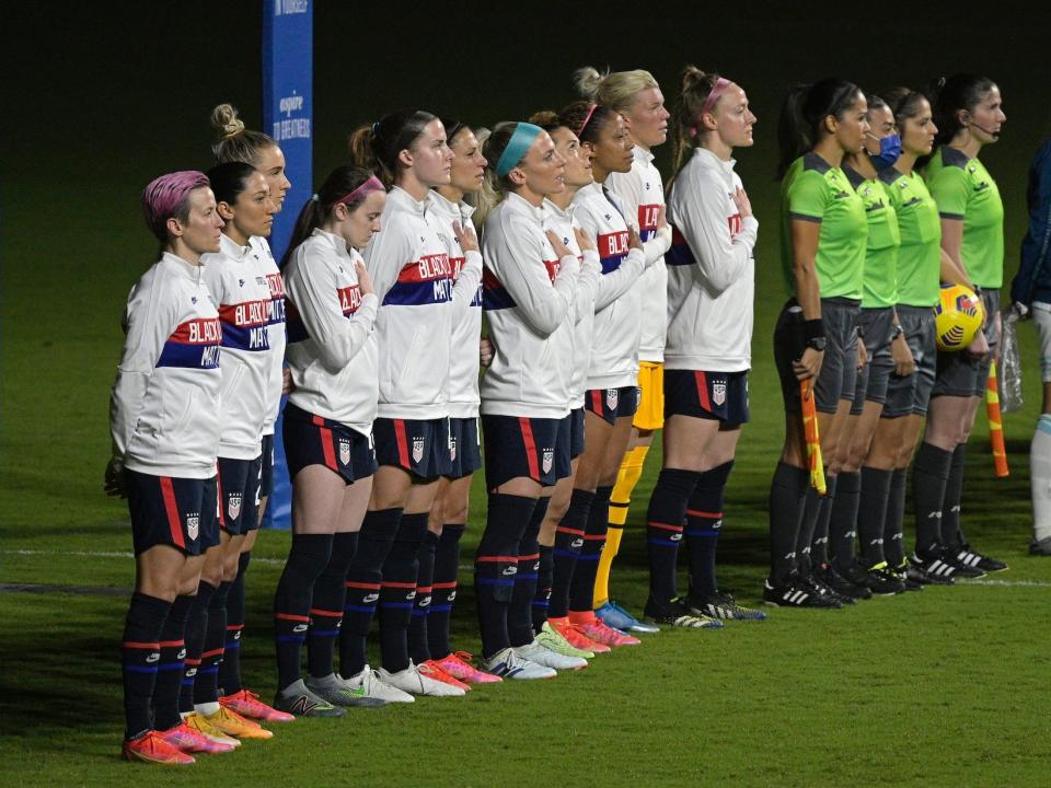 megan rapinoe stands