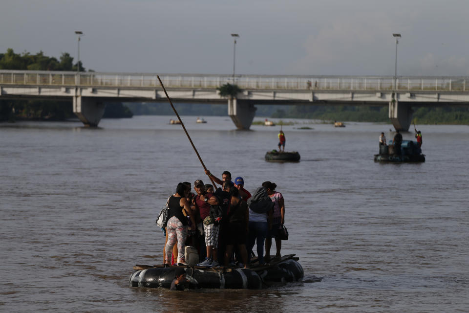 Migrants cross by raft from Tecun Uman, Guatemala, left, to Ciudad Hidalgo, Mexico, on Friday, June 14, 2019. Raftsmen and riverfront business operators said the flow of migrants through the crossing has decreased noticeably since the announcement a few days ago that Mexico's new National Guard would be deploying to the border. (AP Photo/Rebecca Blackwell)