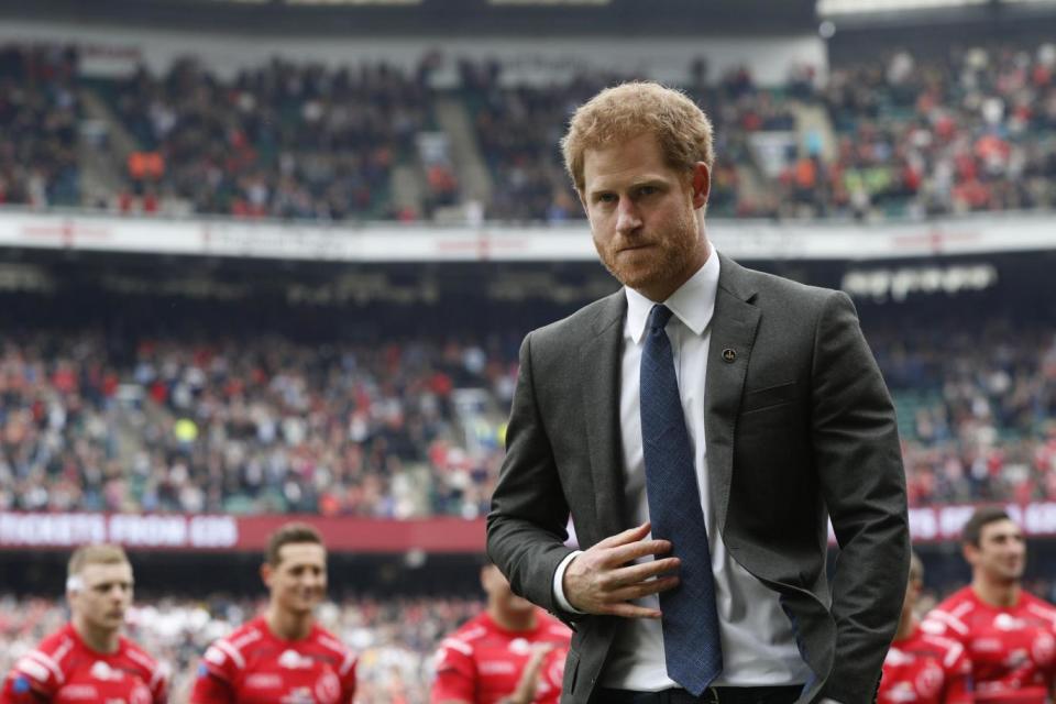 Comfort: Prince Harry prepares to takes his seat at the Army V Royal Navy annual rugby match (PA)