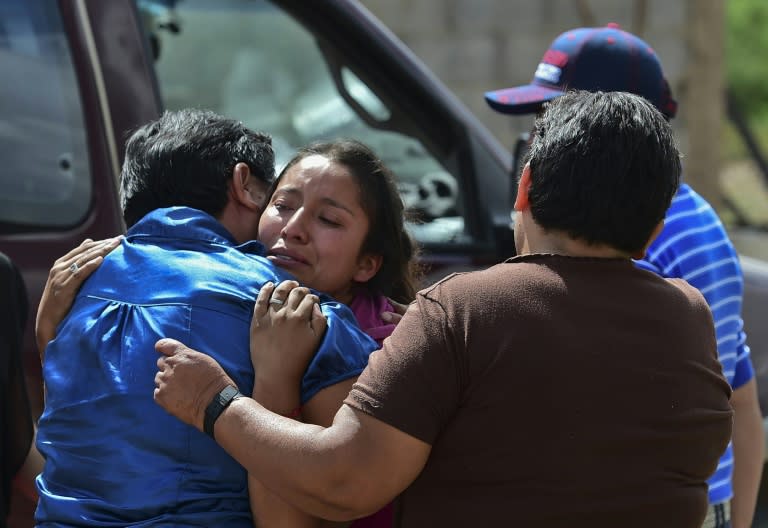 Relatives of a victim of the truck accident cry during the funeral in Santa Rosa, Mexico, on July 30, 2015