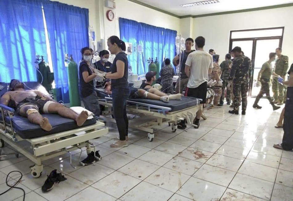 In this photo provided by WESMINCOM Armed Forces of the Philippines, bomb victims receive treatment in a hospital after two bombs exploded outside a Roman Catholic cathedral in Jolo, the capital of Sulu province in southern Philippines where militants are active Sunday, Jan. 27, 2019. The Philippine government says it will "pursue to the ends of the earth the ruthless perpetrators" behind bomb attacks that killed over a dozen people and wounded many more during a Sunday Mass at a cathedral on the restive southern island. (WESMINCOM Armed Forces of the Philippines Via AP)