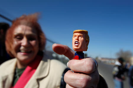 A Trump supporter shows off a doll of U.S. President Donald Trump while waiting to enter El Paso County Coliseum for a rally by President Trump in El Paso, Texas, U.S. February 11, 2019. REUTERS/Jose Luis Gonzalez