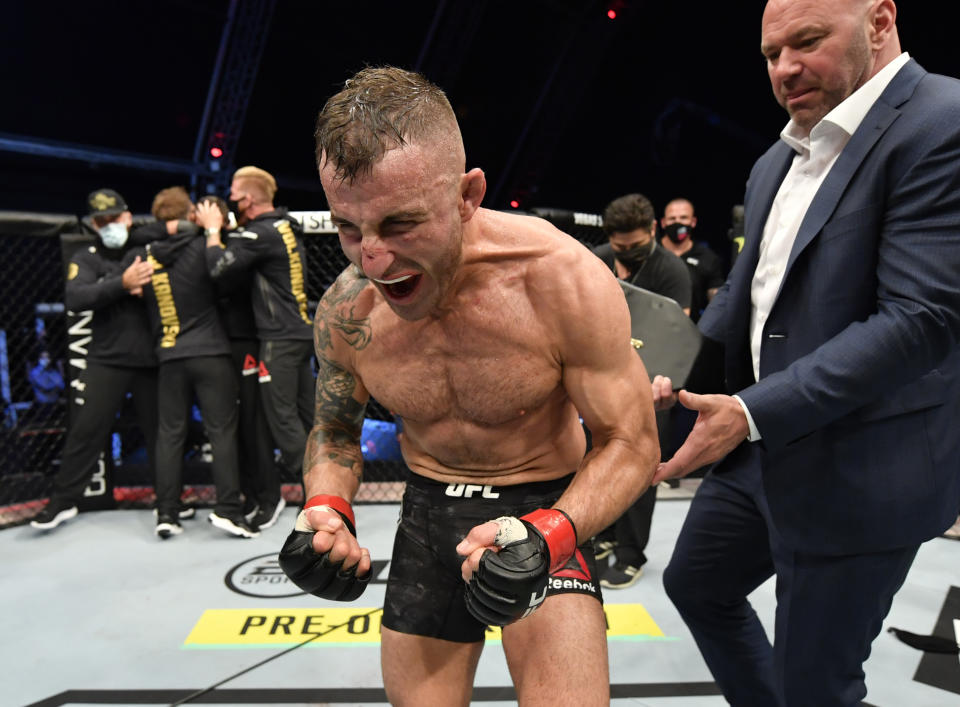 Alexander Volkanovski celebrates after his split-decision victory over Max Holloway in their UFC featherweight championship fight during the UFC 251.