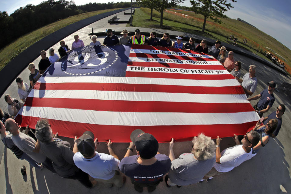 Visitors to the Flight 93 National Memorial in Shanksville, Pa., participate in a sunset memorial service on Tuesday, Sept. 10, 2019, as the nation prepares to mark the 18th anniversary of the Sept. 11, 2001 attacks. (AP Photo/Gene J. Puskar)