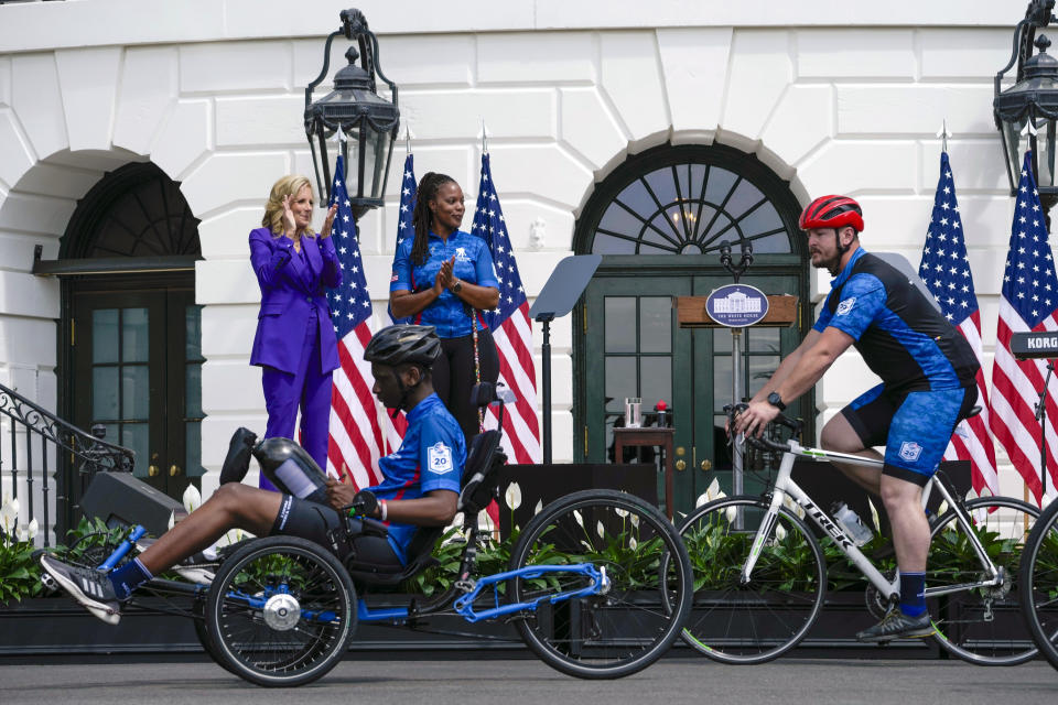 First lady Jill Biden, left, and Sharona Young, retired naval chief petty officer, second from left, watch as wounded warrior riders begin the Wounded Warrior Project's Soldier Ride on the South Lawn of the White House in Washington, Wednesday, April 24, 2024. (AP Photo/Susan Walsh)