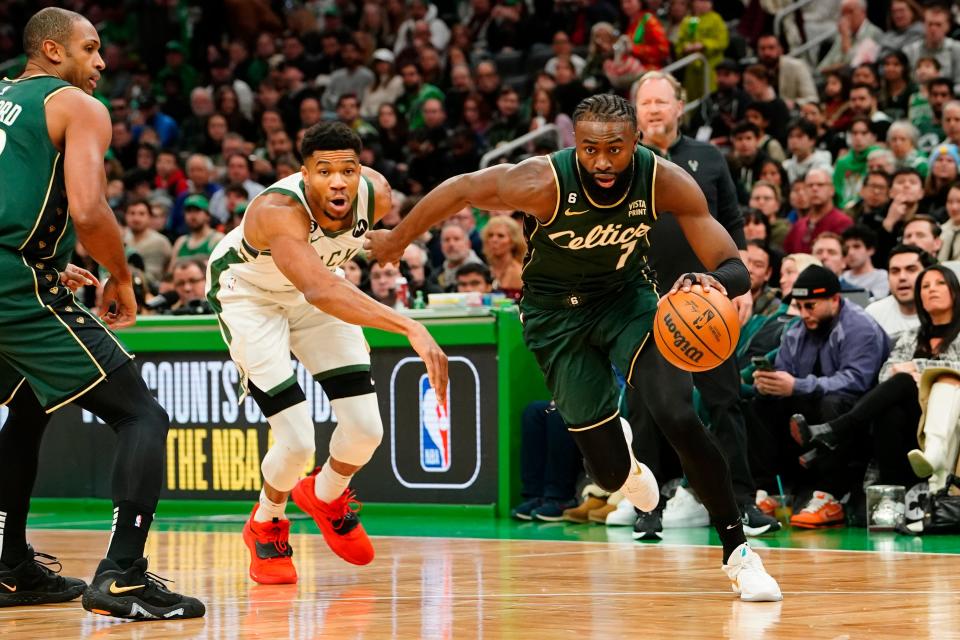 The Boston Celtics' Jaylen Brown (7) drives the ball against the Milwaukee Bucks' Giannis Antetokounmpo (34) during the first quarter at TD Garden.