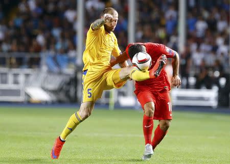 Kazakhstan's Renat Abdulin (L) fights for the ball with Turkey's Arda Turan during their Euro 2016 Group A qualifying soccer match at the Central Stadium in Almaty, Kazakhstan, June 12, 2015. REUTERS/Shamil Zhumatov