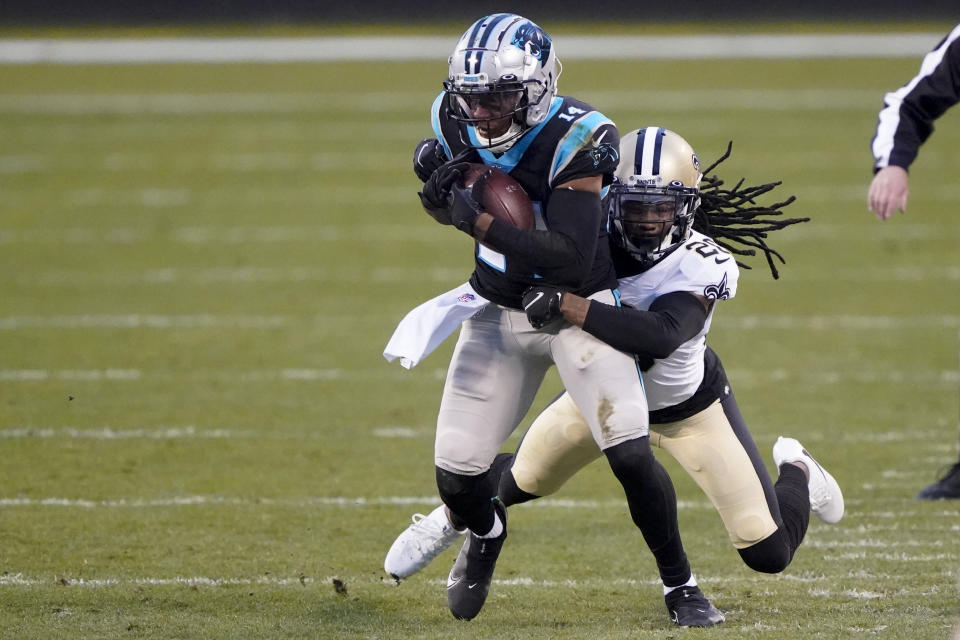 Carolina Panthers wide receiver Pharoh Cooper is tackled by New Orleans Saints cornerback Janoris Jenkins during the first half of an NFL football game Sunday, Jan. 3, 2021, in Charlotte, N.C. (AP Photo/Brian Blanco)