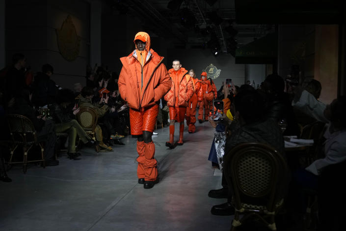 Models wear creations as part of the K-Way menswear Fall-Winter 2023-24 collection presented in Milan, Italy, Saturday, Jan. 14, 2023. (AP Photo/Antonio Calanni)
