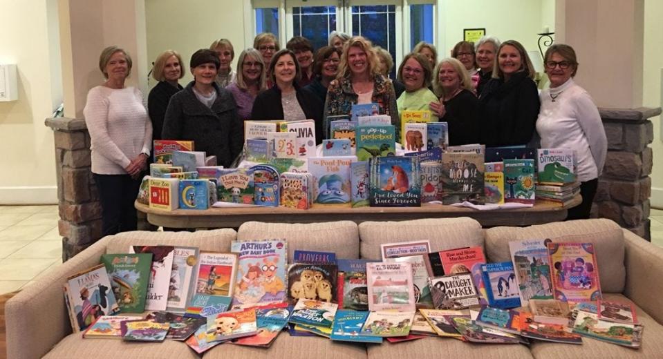 Members of the Bayfront at Rehoboth book club sponsored a neighborhood children's book drive to benefit Read Aloud Delaware, in celebration of March as National Reading Month. More than 200 books were presented to Read Aloud Delaware's Sussex County Coordinator Stacy Penaranda, front row, center. [PHOTO PROVIDED]