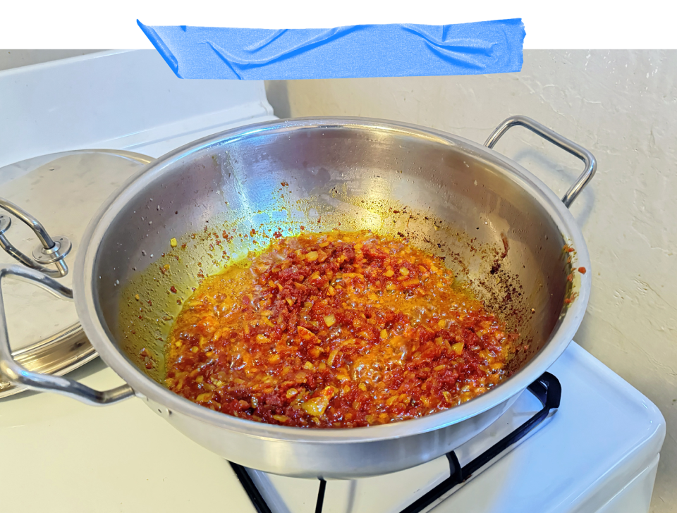 Simmering spices, alliums and tomatoes blend in a pot — the foundation of jollof rice. (Courtesy Adjoa Kittoe)