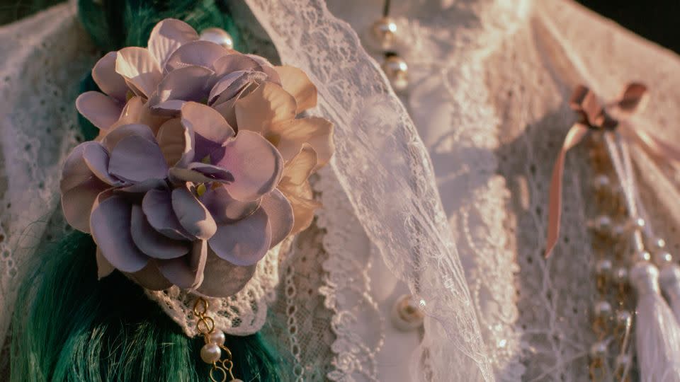 Kandace accessorized her outfit with pearls, lace, and flowers, while attending a tea party in the Morcom Rose Garden in Oakland, California, on Feb. 25, 2021. Lolitas often wear wigs in combination with other headwear such as hair bows or bonnets. - Shelby Knowles