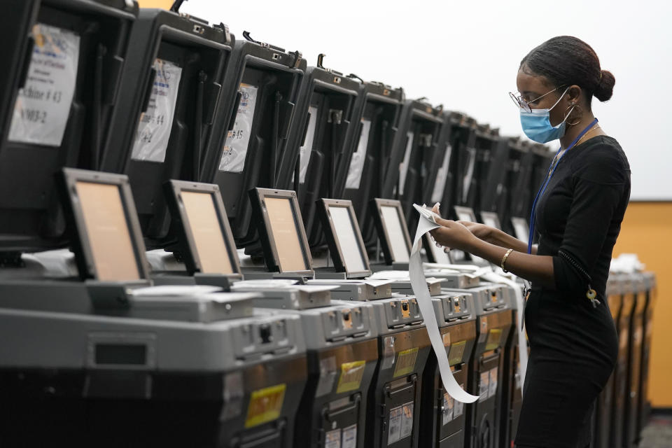 An employee at the Broward Supervisor of Elections Office conducts logic and accuracy testing of equipment used for counting ballots, Thursday, Sept. 24, 2020, in Lauderhill, Fla. Vote-by-mail ballots for the general election will begin going out to residents in Broward County Thursday. (AP Photo/Lynne Sladky)