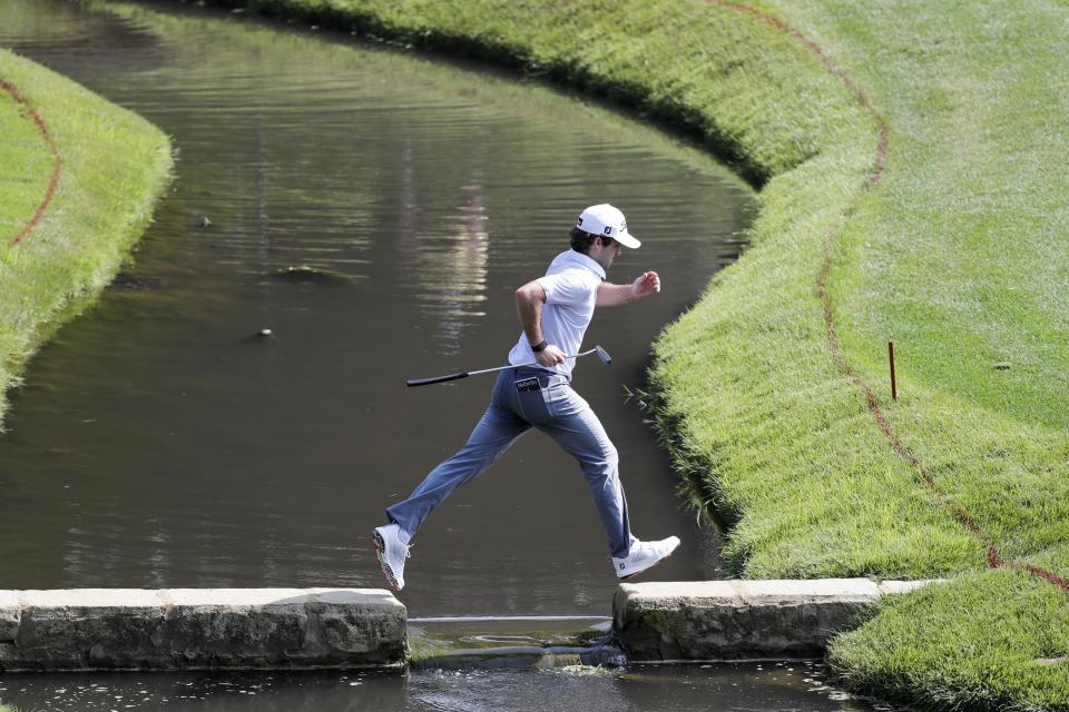 Denny McCarthy jumps across a bridge on the 14th hole during opening round of the Workday Charity Open golf tournament, Thursday, July 9, 2020, in Dublin, Ohio. (AP Photo/Darron Cummings)