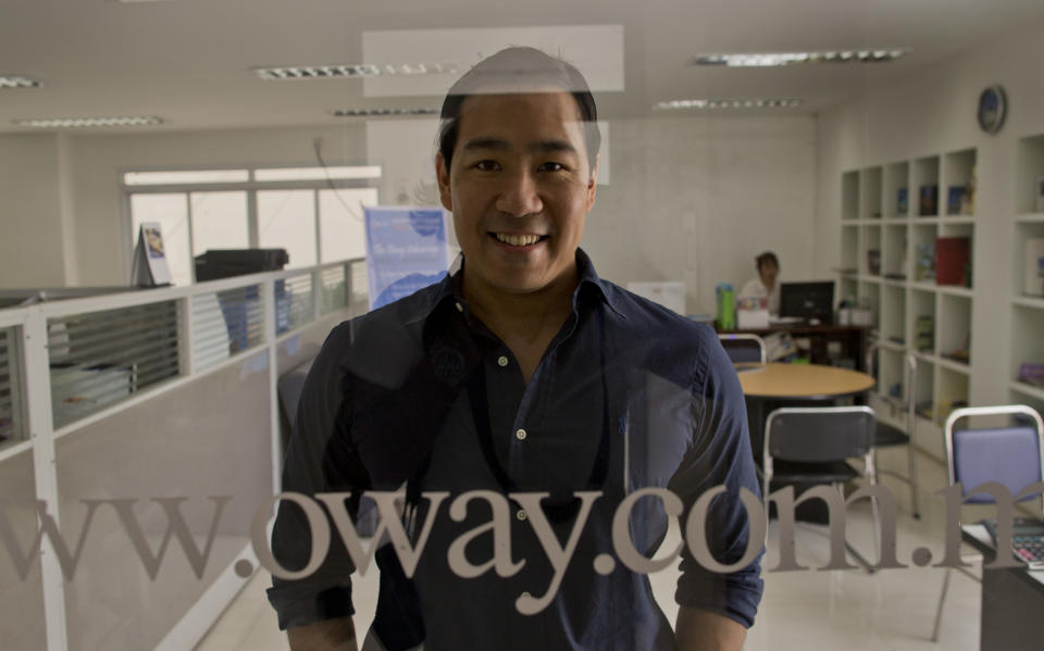 In this April 12, 2014 photo, Nay Aung, founder of Oway company poses in his office, Yangon, Myanmar. Nay Aung, a 34-year-old Stanford graduate and former business operations and strategy manager at Google Inc., is among a vanguard of overseas-trained professionals who have returned to Myanmar to find both opportunities and challenges. (AP Photo/Gemunu Amarasinghe)