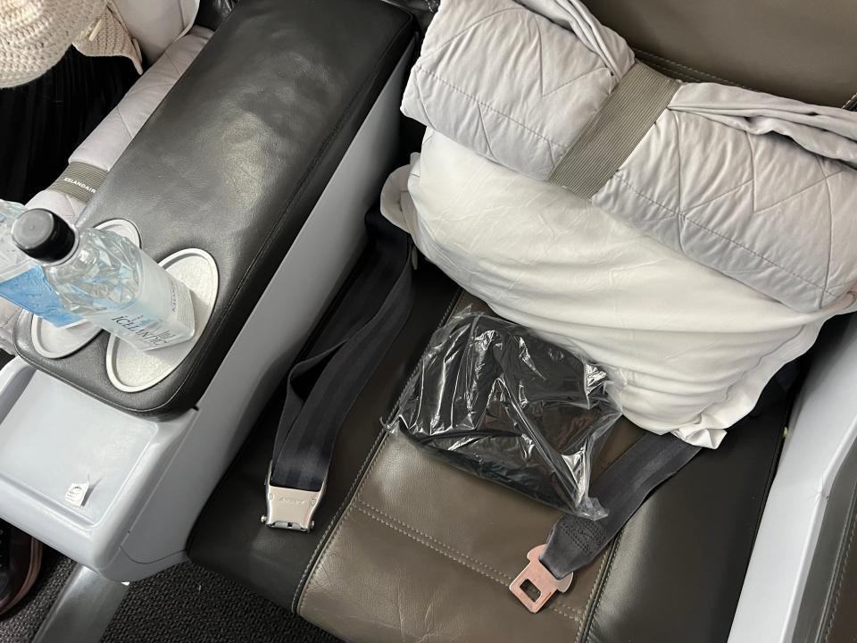 pillow and blanket on chair on plane