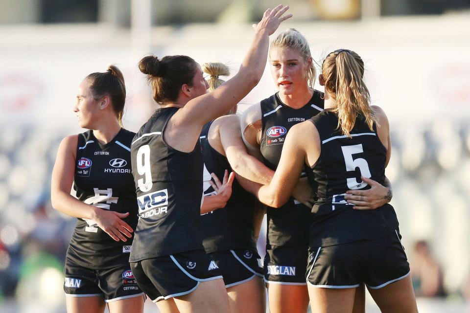 Tayla Harris celebrates with teammates during an AFLW match. (Getty Images)