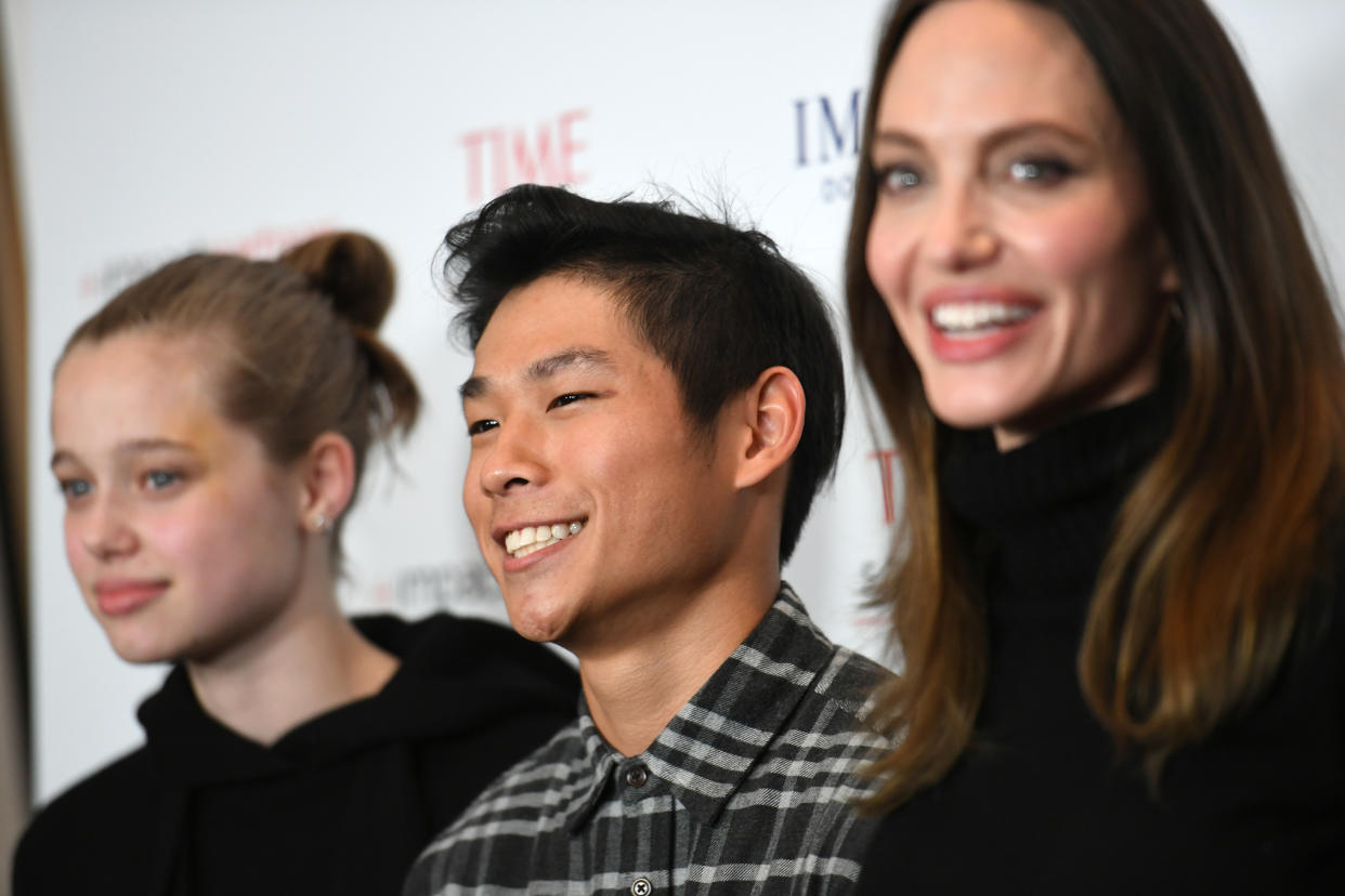 LOS ANGELES, CALIFORNIA - NOVEMBER 18: (L-R) Shiloh Jolie-Pitt, Pax Thien Jolie-Pitt and actress Angelina Jolie attend the Los Angeles premiere of MSNBC Films' 