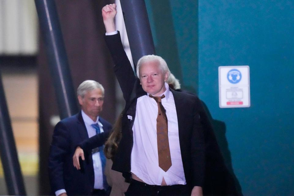 WikiLeaks founder Julian Assange waves after landing at RAAF air base Fairbairn in Canberra (AP)