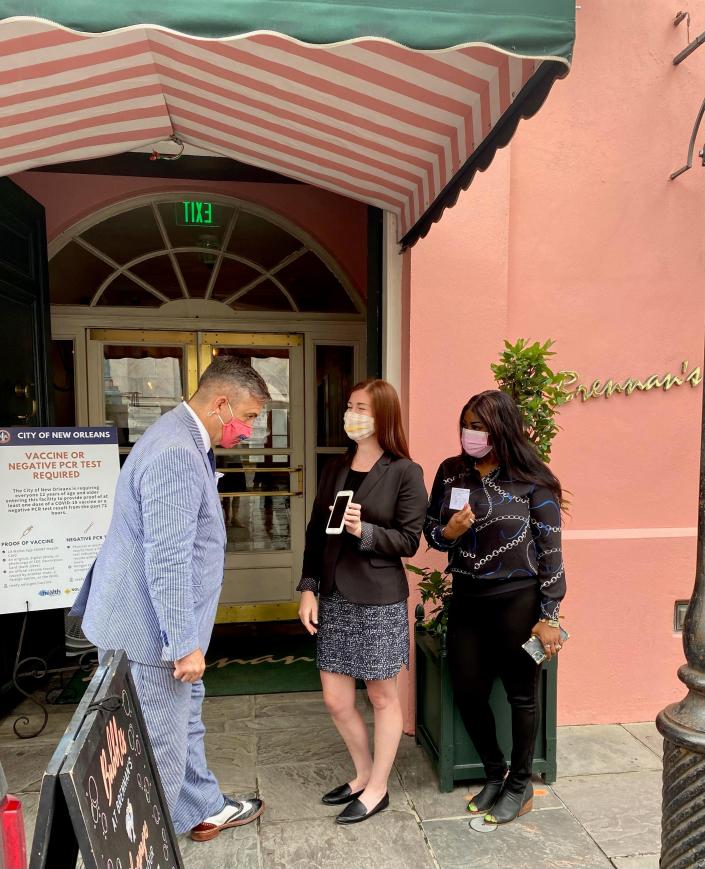 Christian Pendleton, general manager at Brennan&#39;s restaurant in the French Quarter, greets guests and requests vaccine cards during the first week of New Orleans&#39; citywide vaccine mandate for bars, restaurants and entertainment venues.