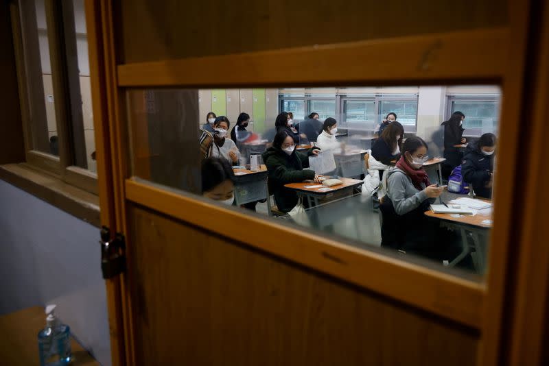 Students wait for the start of the annual college entrance examinations amid the coronavirus disease (COVID-19) pandemic at an exam hall in Seoul