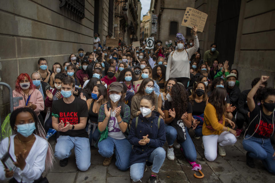 People gather in Barcelona, Spain, Sunday, June 7, 2020, during a demonstration over the death of George Floyd, a black man who died after being restrained by Minneapolis police officers on May 25. (AP Photo/Emilio Morenatti)