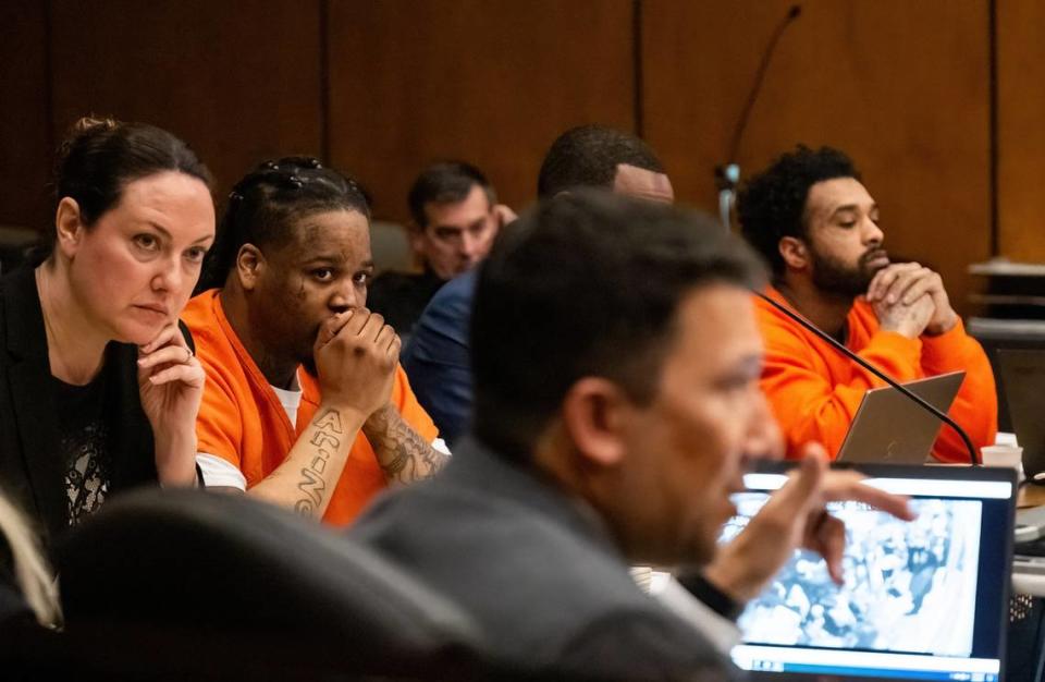 Murder suspects Smiley Martin, 23, left, and Mtula Payton, 29, listen to prosecutor Brad Ng, foreground, question a cousin of victim Sergio Harris during a preliminary hearing in Sacramento Superior Court on Tuesday in the case of the April 2022 mass shooting in downtown Sacramento. Ng’s computer screen shows video evidence that was projected in the courtroom depicting a nightclub on the night of the shooting. Nathaniel Levine/nlevine@sacbee.com