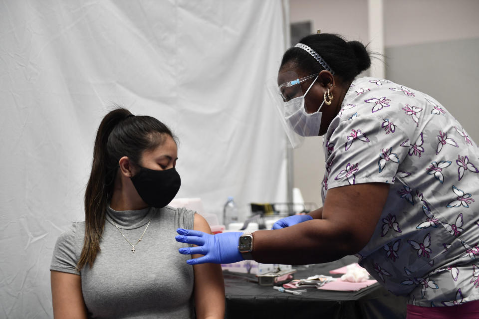 A nurse administers a vaccine