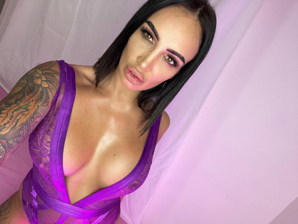 Hayley's raunchy Instagram selfie with plunging purple bodysuit.