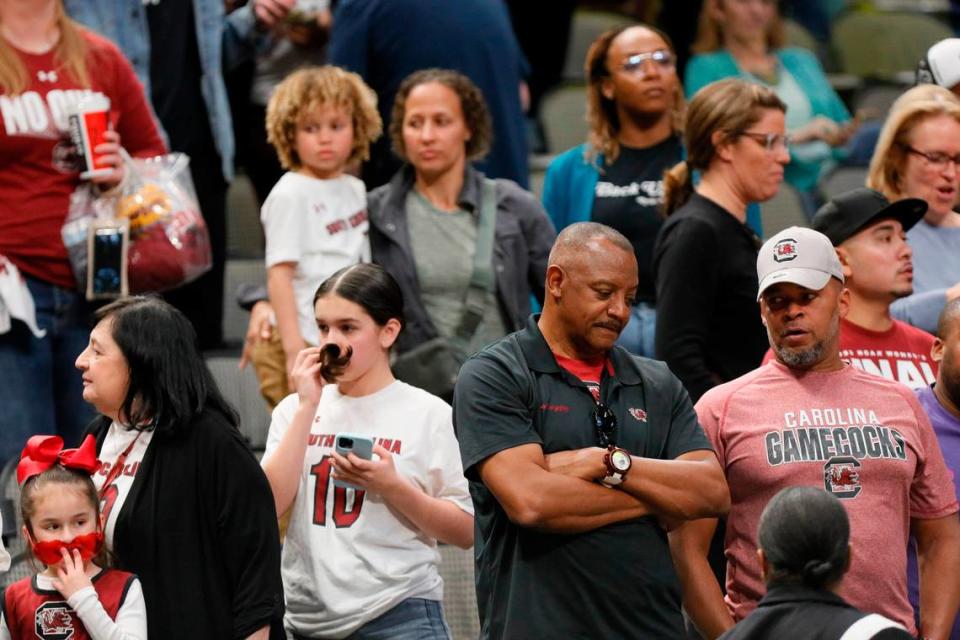 South Carolina fans quietly leave the stadium after their team loses to Iowa in the NCAA Tournament Final Four game at the American Airline Center on Friday, March 31, 2023.