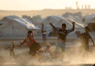 <p>Displaced Iraqis play football during the Muslim holy month of Ramadan at al-Khazir camp for the internally displaced, located between Arbil and Mosul, on June 5, 2017. (Photo: Karim Sahib/AFP/Getty Images) </p>