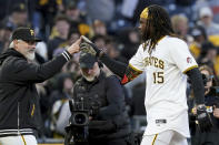 Pittsburgh Pirates' Oneil Cruz, right, celebrates with manager Derek Shelton, left, after hitting a walkoff single during the 11th inning of a baseball game against the Baltimore Orioles, Saturday, April 6, 2024, in Pittsburgh. (AP Photo/Matt Freed)