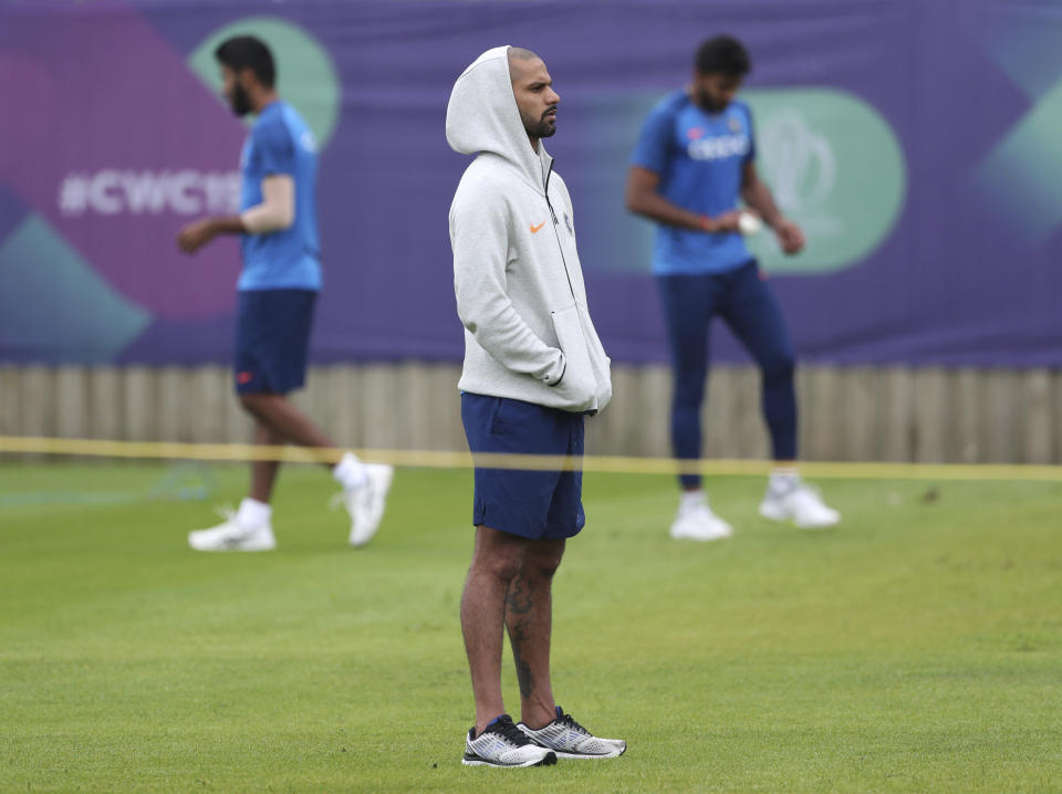 India's Shikhar Dhawan watches teammates bat at the nets during a training session ahead of their Cricket World Cup match against Afghanistan at the Hampshire Bowl in Southampton, England, Wednesday, June 19, 2019. (AP Photo/Aijaz Rahi)