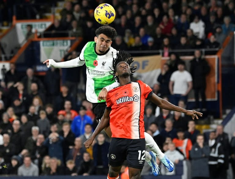 Luis Diaz (L) heads in Liverpool's injury-time equaliser at Luton (JUSTIN TALLIS)