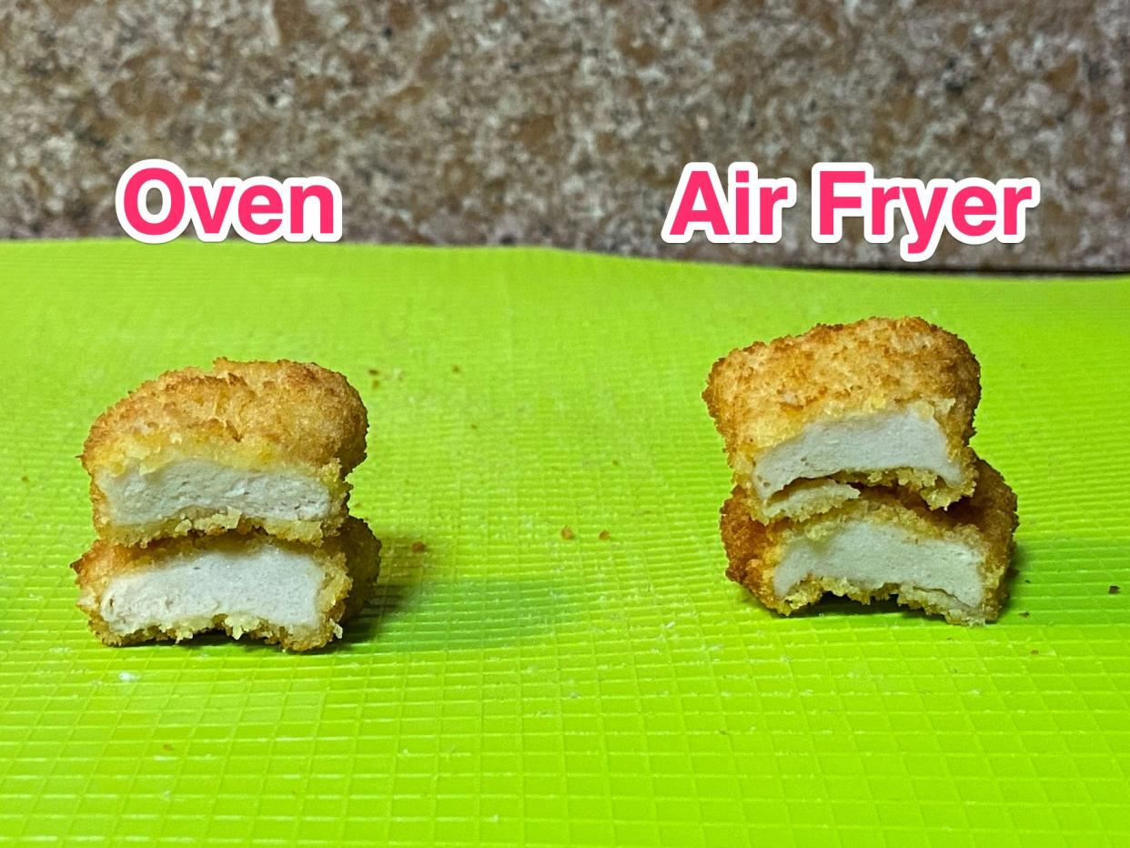 Side my side images of an oven baked chicken nugget cut in half and stacked showing the inner white meat next to another chicken nugget that was heated in an air fryer. The oven baked nugget meat looks firm but with a shredded consistency and the air fried nugget looks similar but with the breadcrumb shell slightly separated from the meat.