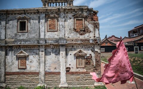 An old Western style house still bears bullet holes and damage from the Battle of Guningtou, an attempted invasion of Kinmen by Communist forces in 1949 - Credit: Carl Court/Getty&nbsp;